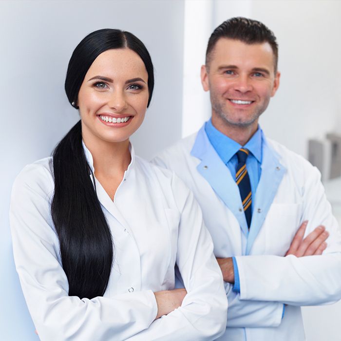 two dentists smiling at camera