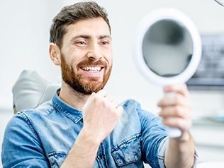 man checking smile in circle mirror