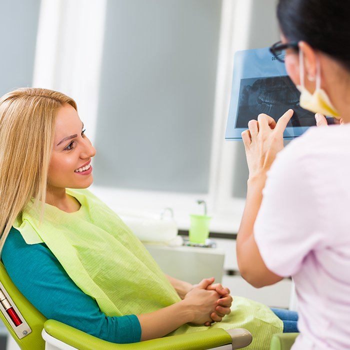 assistant showing patient x-ray