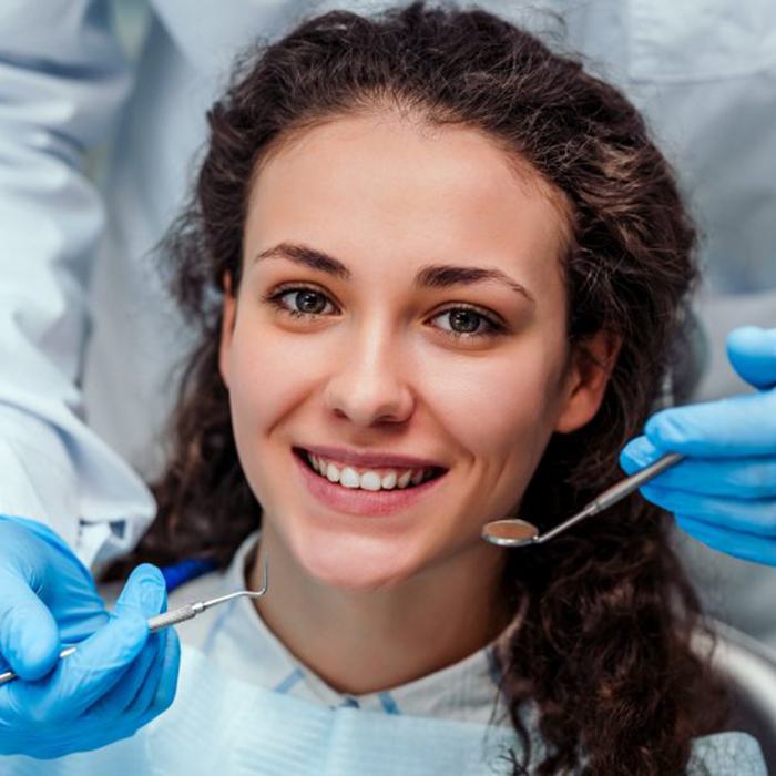 young woman smiling in dental chair 