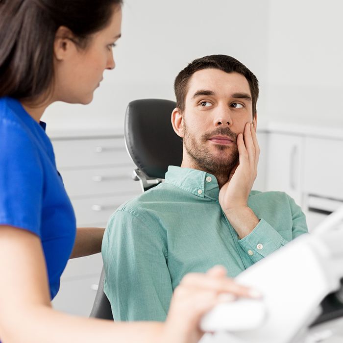 man in green shirt with dental emergency