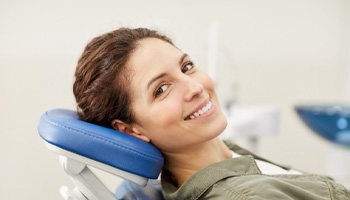 : a smiling person in a dental chair