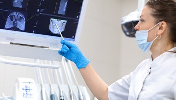 a dentist looking at an X-ray