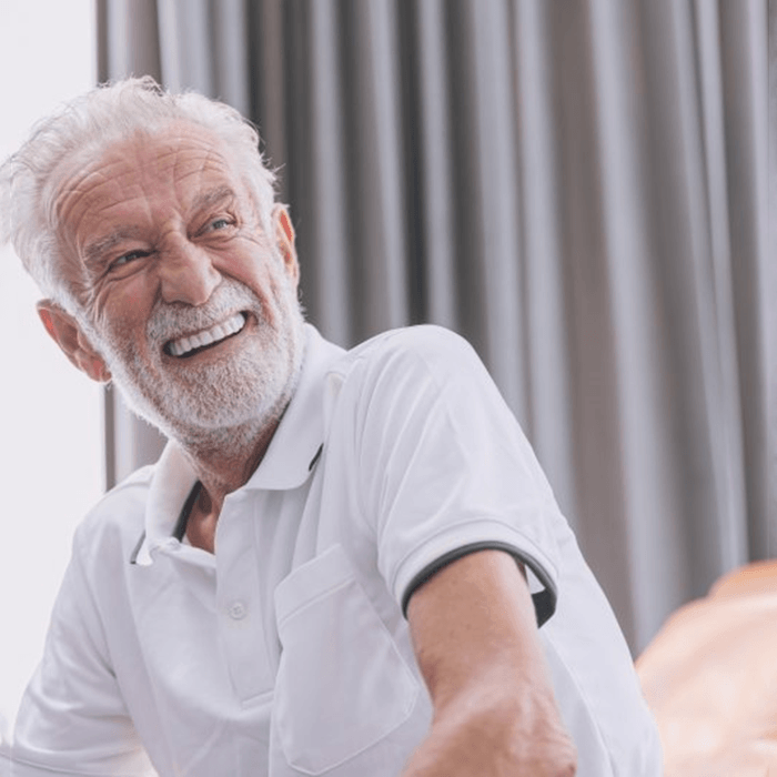 a man smiling with his new dental implants