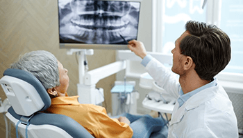 a patient with dental implants visiting her dentist