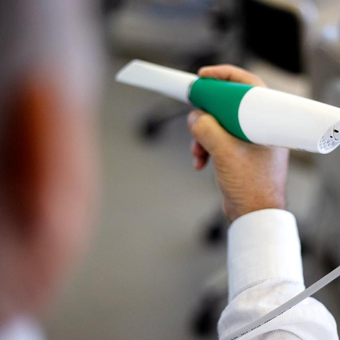 dentist holding intraoral camera