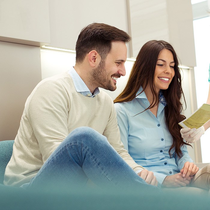 Couple smiling and looking at paperwork