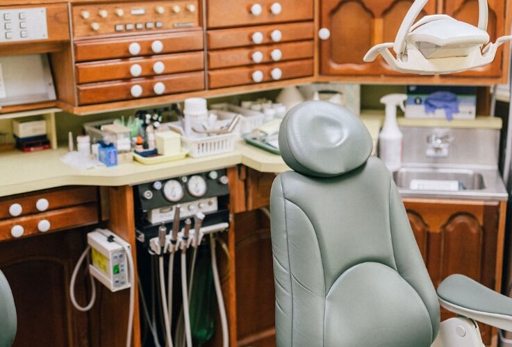 Dental Hygientist performing a dental cleaning on patient