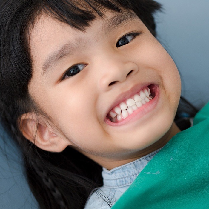 young girl showing off teeth