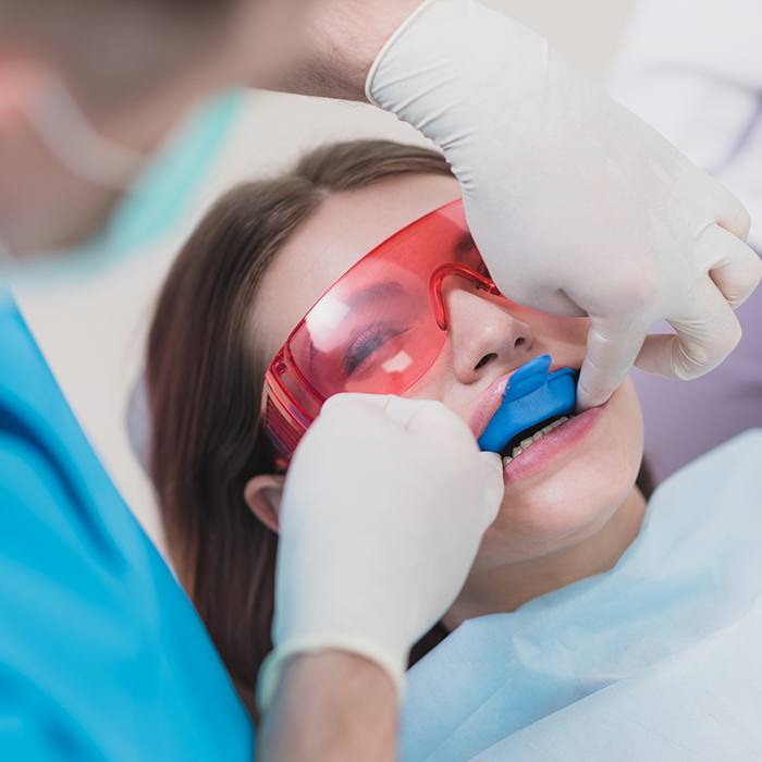 girl with protective glasses getting fluoride treatment