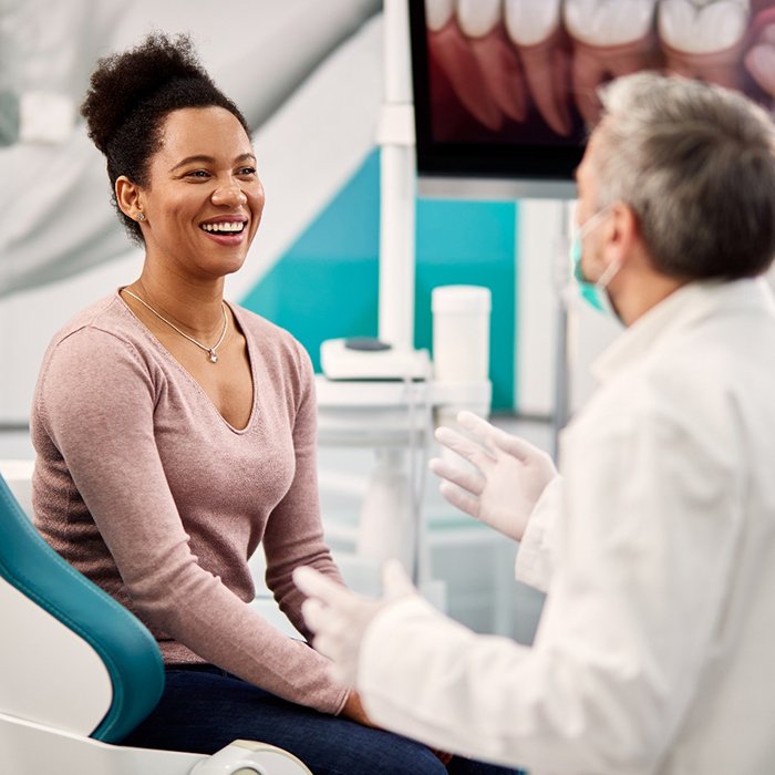 Dentist explaining treatment to patient in office