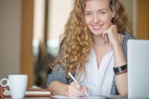 woman at work desk smiling