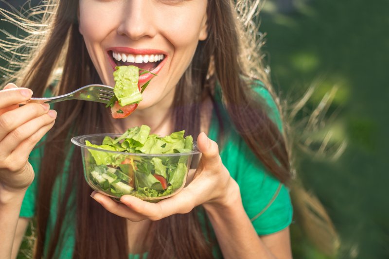 woman eating salad for National Nutrition Month in Charlottesville