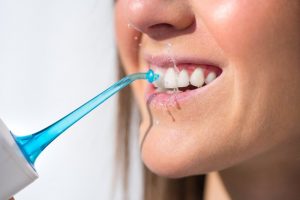 woman using oral irrigator