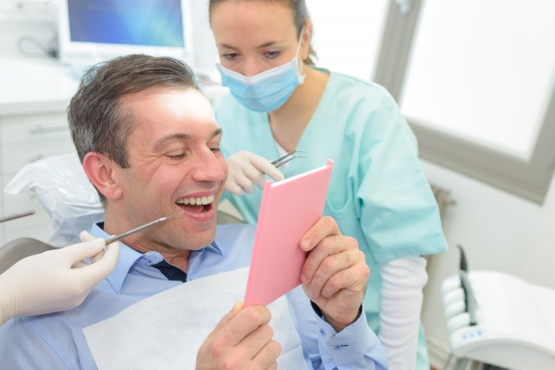 man smiling after getting dental crown in Charlottesville