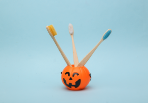 toothbrushes in a pumpkin-themed cup